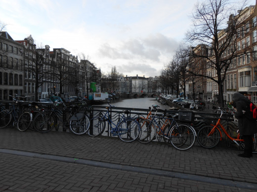 Bikes are everywhere in Amsterdam. Here's a familiar sight of bikes being parked along a canal bridge.