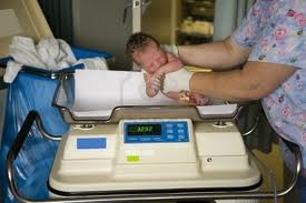 weighing the baby.