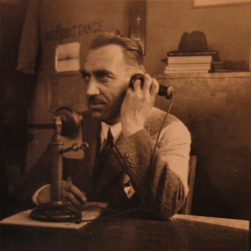 A Man Using an Early Telephone