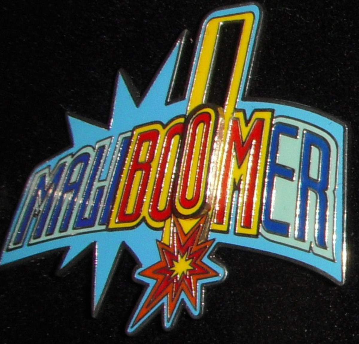 Pin for the MaliBoomer attraction has a sliding feature, the letter O.