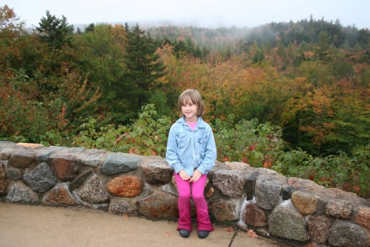 Autumn ~ Our daughter sitting on a wall along the Kankamangis Scenic Highway in NH