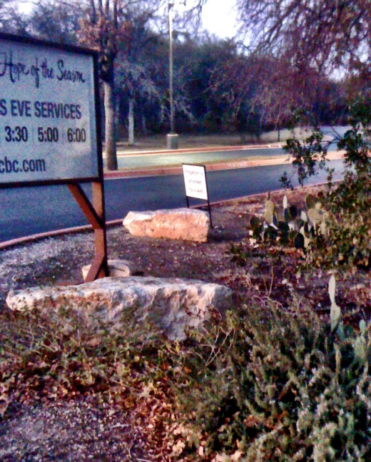 Large stones accent the entrance to a commercial property.