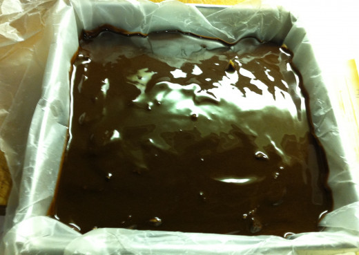 Pour melted chocolate over the peanut butter fudge. Place in fridge for at least one hour before cutting.
