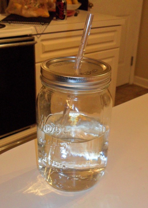 Mason jar with a hole for a straw.
