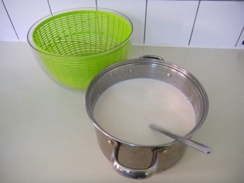 Get a yogurt strainer o a plastic salad spinner, the size of your yogurt container.