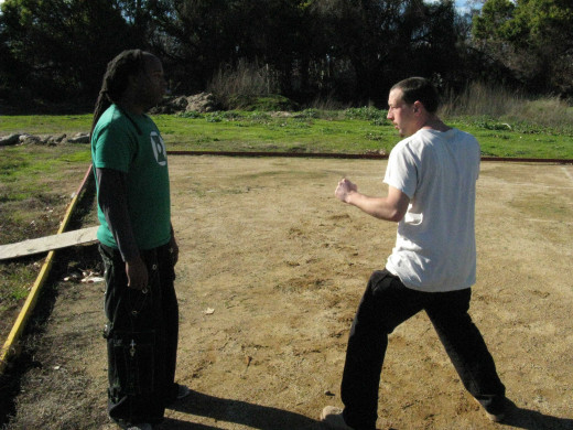 Glenn and Jamie demonstrate a Kenpo technique called the Dance of Death, against a right step-through thrust punch.