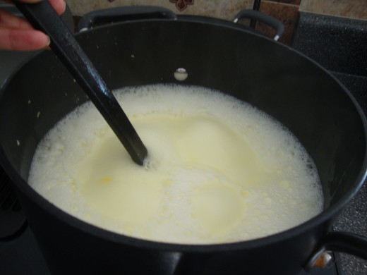 Stirring the mixture of Fels Naptha soap and water until it is completely melted and blended
