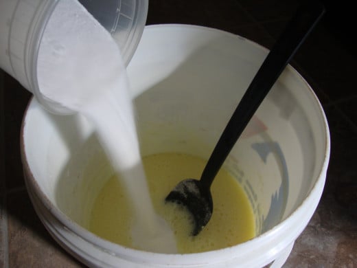 After pouring the mixture into a large bucket, pour in the 2 cups of Borax and the 2 cups Washing Soda, stirring thoroughly until well mixed.