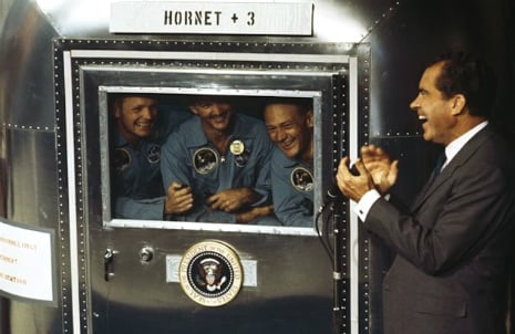 President Nixon greets the Apollo 11 astronauts aboard the USS Hornet. The astronauts were in quarantine for a few weeks to guard against space microbes.