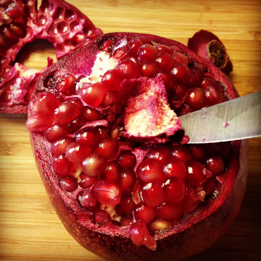 Using the tip of your knife, remove a little more of the inner center membrane to free up the pomegranate