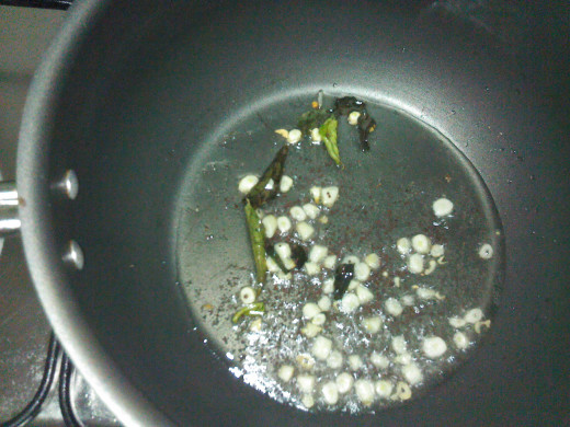 Fry garlic and curry leaves in oil