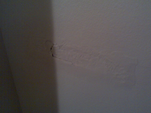 Hole in the wall behind our bedroom door.