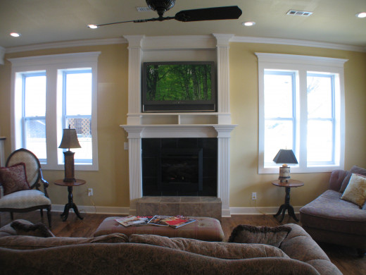 This fireplace was added specifically to house a TV and its components.  The woodwork ties into the window surrounds.