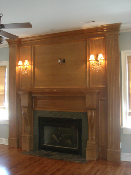 AFTER Now this fireplace makes a statement! By taking it all the way to the ceiling, adding architectural details, sconces, and custom tile work, it has truly become the centerpiece of the room.