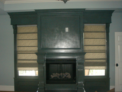 AFTER By incorporating the flanking windows into the design, a small fireplace looks massive and became the focal point for this master bedroom.