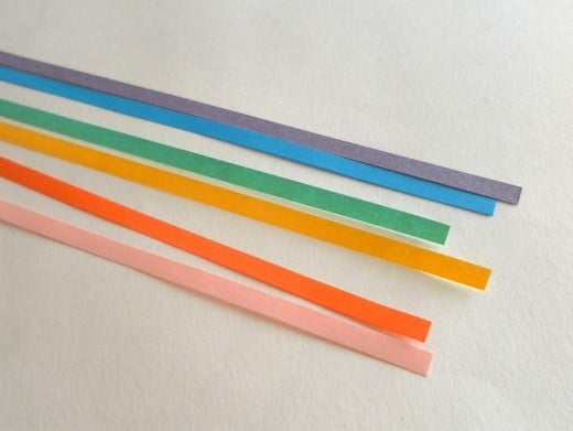 Take strips of coloured quilling paper