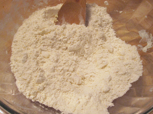 Butter is crumbled into flour.
