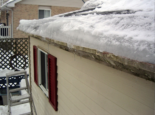 A view of the ice dam which is preventing the melted snow from flowing off the roof.