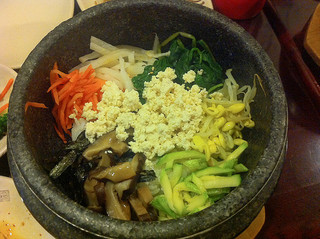 A bibimbap dish made with vegetables and tofu
