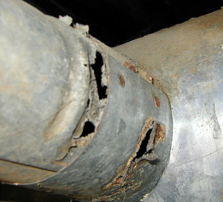 Flue and vent rusted and corroded - unsafe - Potential carbon monoxide hazard.
