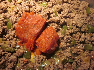 Cooked ground beef with sauce added