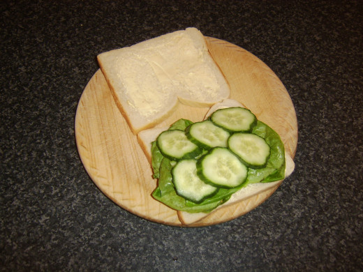 Cucumber slices are laid on top of lettuce