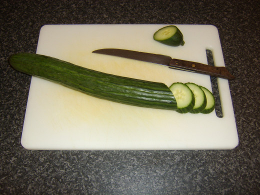 Cucumber is sliced at an angle to provide larger, more attractive slices