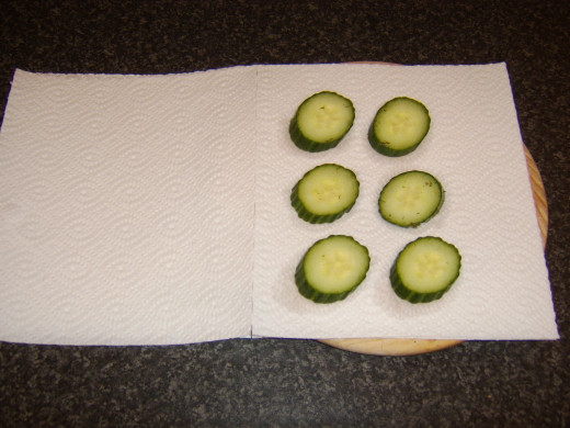Pickled cucumber is patted dry in kitchen paper