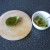 Flesh is scooped out of avocado half with a teaspoon