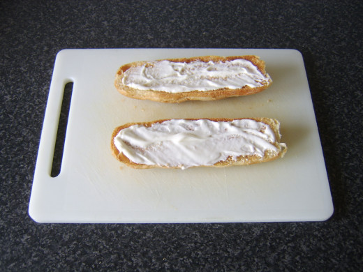 Mayo is spread on both halves of the toasted sub