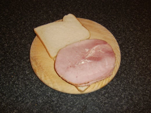 Two thick slices of honey roast ham are laid on cottage cheese