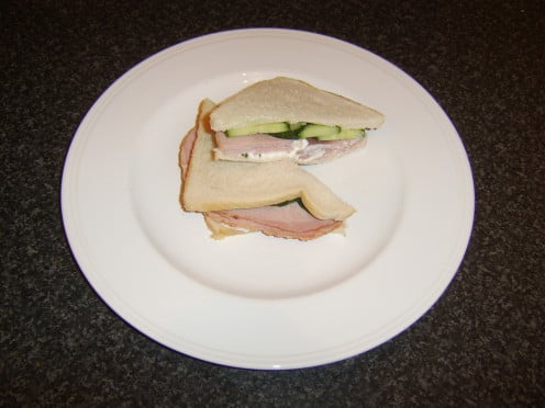 Onion and chive cottage cheese is topped with honey roast ham and cucumber in this sandwich