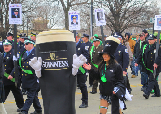 Chicago Police Officers with a Guinness Mascot walking next to them.
