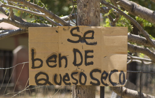 A hand-lettered sign see alongside a country road on Santa Elena Peninsula in Northwest Costa Rica.  There are many beaches here, which are usually not crowded - and you can get cheap, fresh cheese.