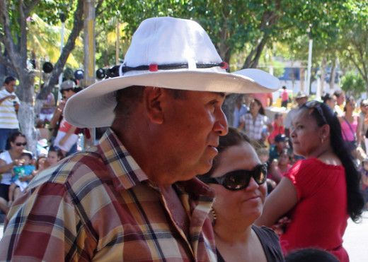 Part of my hats of the fiestas series, which is a work in progress.  Man and his wife standing along the parade route.