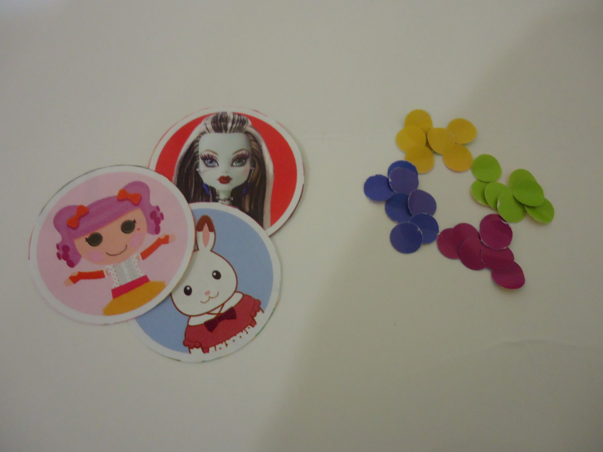 I cut out pictures of toys representing their brand in a toy store catalog (Lalaloopsy, Sylvanian bunny, Monster High doll). The punched out circles are what I used for this tutorial.