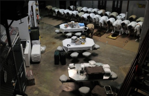 "Delta Block captives kneel during midday prayers at Camp 6, a steel and cement prison building on March 18, 2011 at the U.S. Navy Base at Guantanamo Bay, Cuba, in this image taken and distributed by the U.S. Navy. PETTY OFFICER DAVID P. COLEMAN / US