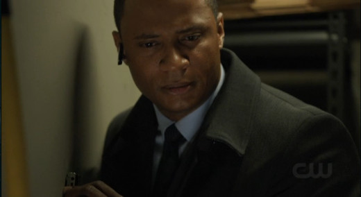 Diggle can hear Moira's voice clearly through the wall, but Merlyn's voice is somehow muffled.