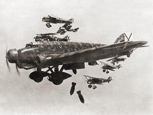 Italian heavy bombers dropping bombs on Madrid in 1936. Incidentally the black crosses are the symbol of the Spanish Air Force.