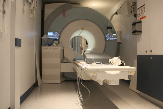 The Open MRI machine is superior because it lessens the chance of a panic attack in a narrow enclosure.  A friend may stand nearby as a source of support.
