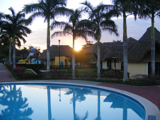 Sun coming up over the main pool. Allegro Resort. Cozumel, Mexico