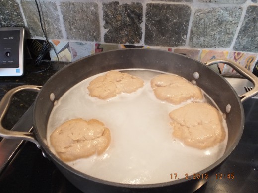 Once the water is boiling and the baking soda is in, drop in 4 to 5 rolls and let them "poach" for 1 minute on each side. This is one side.