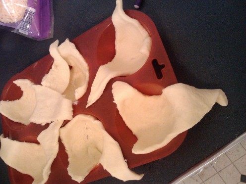 Place crescent rolls into muffin tin and press gently inot cup shape.