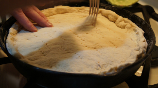 Making holes in the covering dough