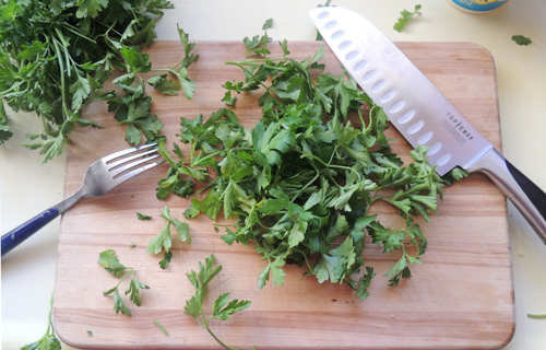 TIP: If you run fork tines through your parsley bunch, gripping bunch firmly by stems, the tines will pull the leaves away from stems, for easy chopping later!