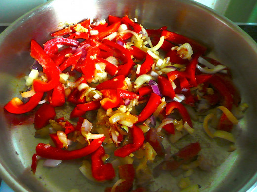 Cook the onions and peppers 