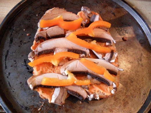 Add the sauce and then the vegetables to your bread pizza