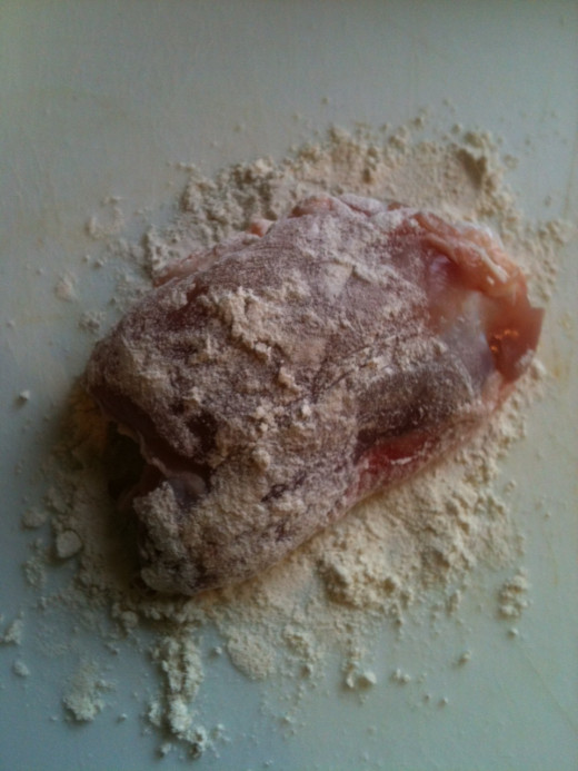 Roll the skinned chicken thighs in plain flour