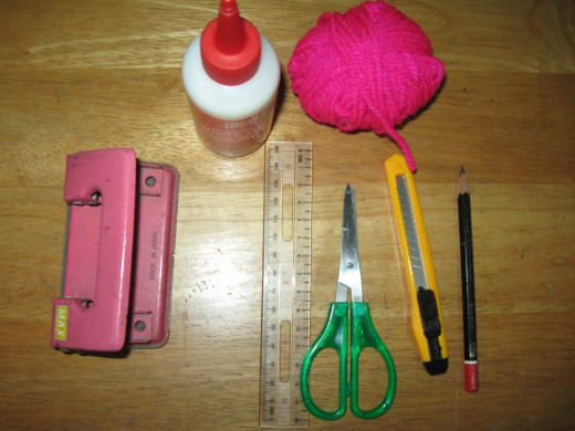 basic stuff: punch holder, white glue, yarn, ruler, scissors, penknife and pencil