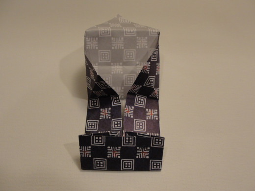 Unfold one end of the paper box, then the opposite end.